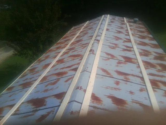 Rusted metal roof panels with new wood purlins before replacement — Storm Damage Roof Repair in Poncha Springs by Roofing Brothers